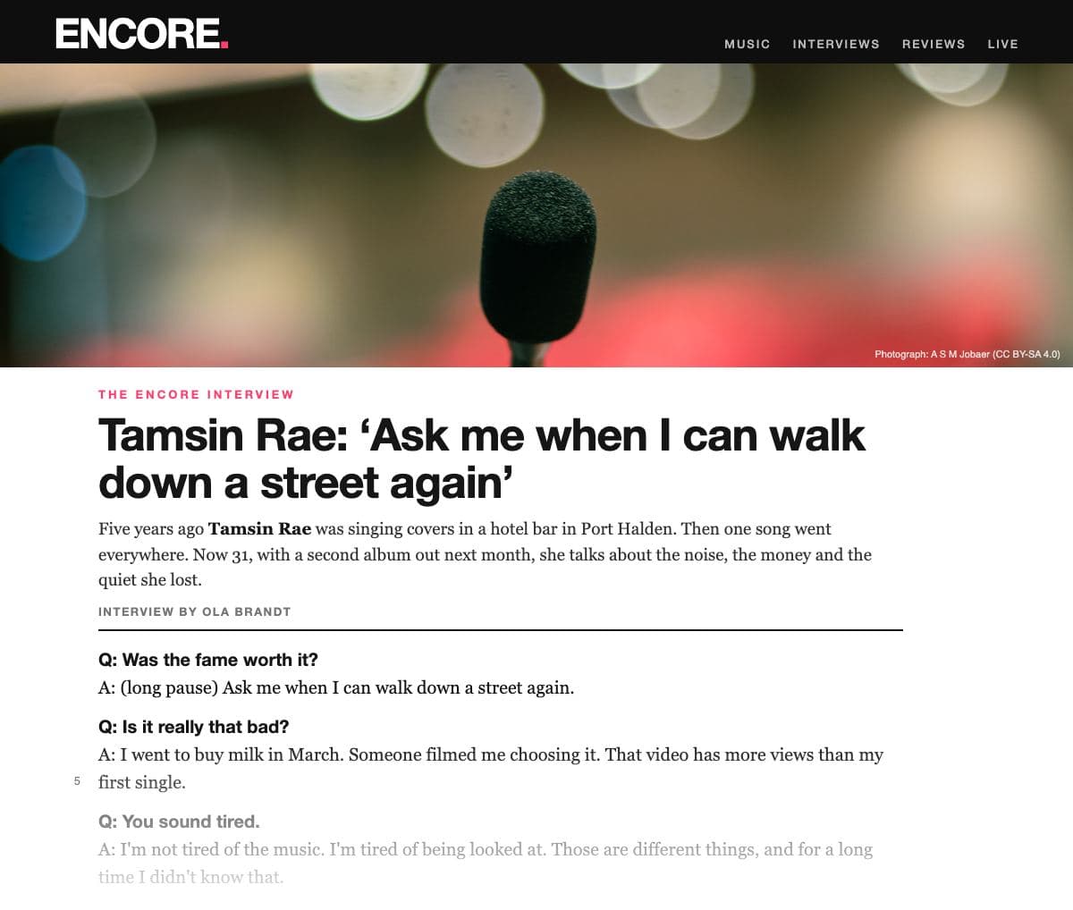 The top of a Q&A interview in the music magazine ‘Encore’: a black masthead band; a wide photograph of a single microphone on a stand in front of blurred stage lights, with no one at it; the tag ‘The Encore interview’; the headline ‘Tamsin Rae: “Ask me when I can walk down a street again”’; an intro paragraph about the singer's sudden fame; ‘Interview by Ola Brandt’; then the questions in bold and the answers in plain type, fading out at the foot of the clipping.