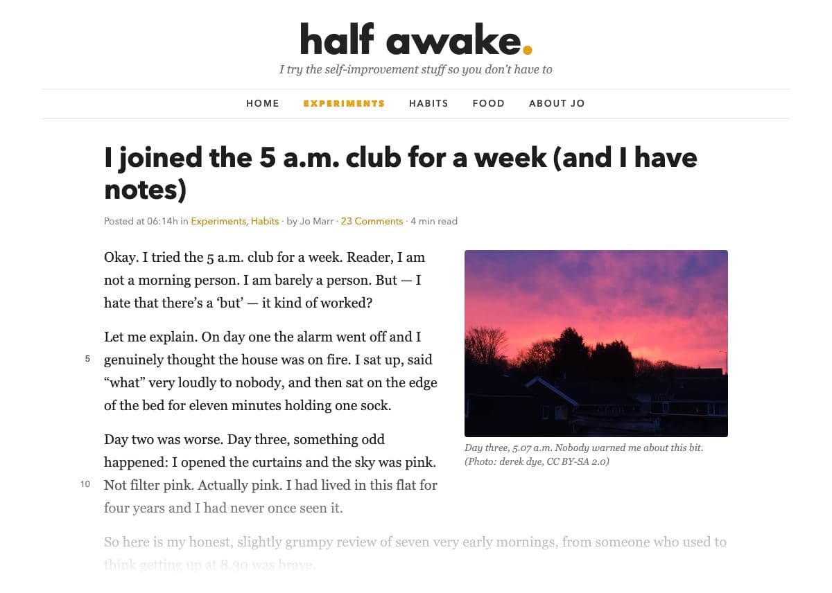 The top of a blog post on ‘half awake.’, a blog with the tagline ‘I try the self-improvement stuff so you don't have to’ and a menu (Home, Experiments, Habits, Food, About Jo); the post title ‘I joined the 5 a.m. club for a week (and I have notes)’; the meta line ‘Posted at 06:14h in Experiments, Habits · by Jo Marr · 23 Comments · 4 min read’; then the opening lines, ‘Okay. I tried the 5 a.m. club for a week…’, wrapped around a photograph of a pink dawn sky over dark rooftops captioned ‘Day three, 5.07 a.m. Nobody warned me about this bit.’, fading out at the foot of the clipping.